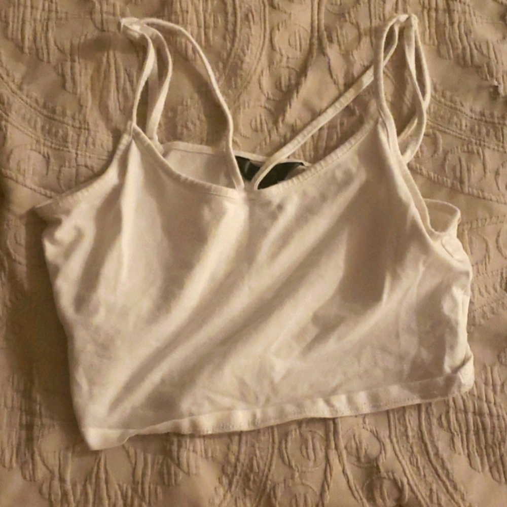 a white tank top and cropped
